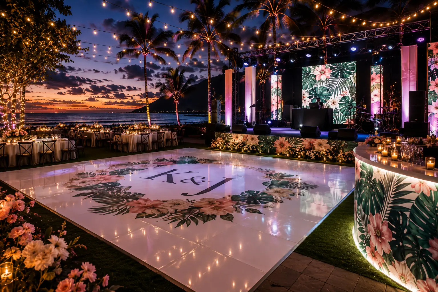 A custom monogram dance floor lit at sunset