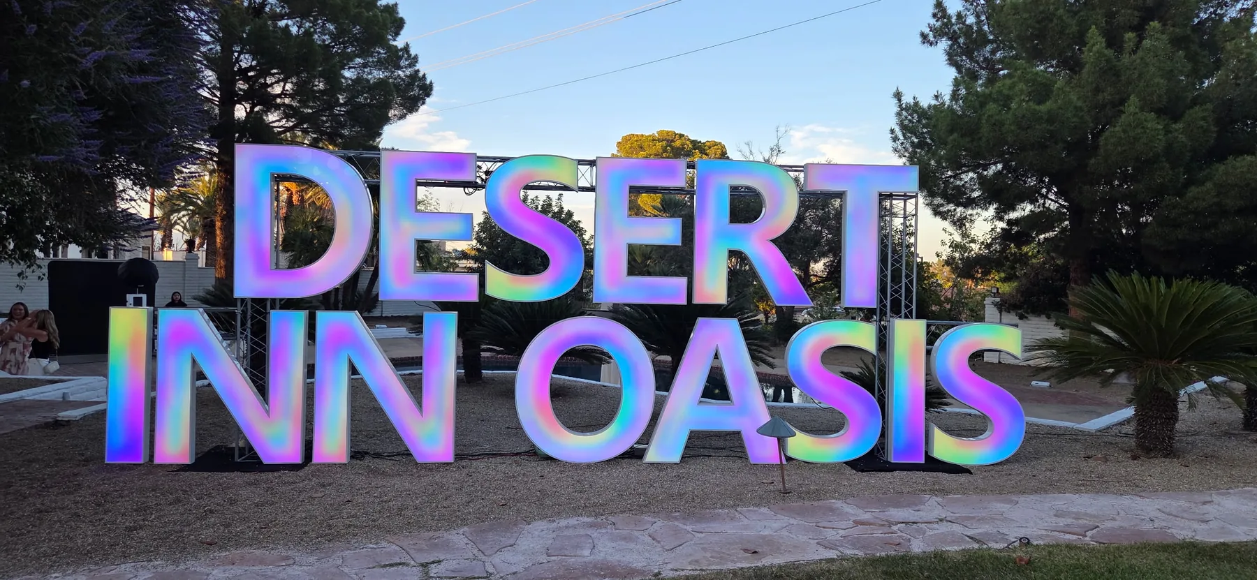 Large DESERT INN OASIS letters illuminated with a multicolor treatment outdoors